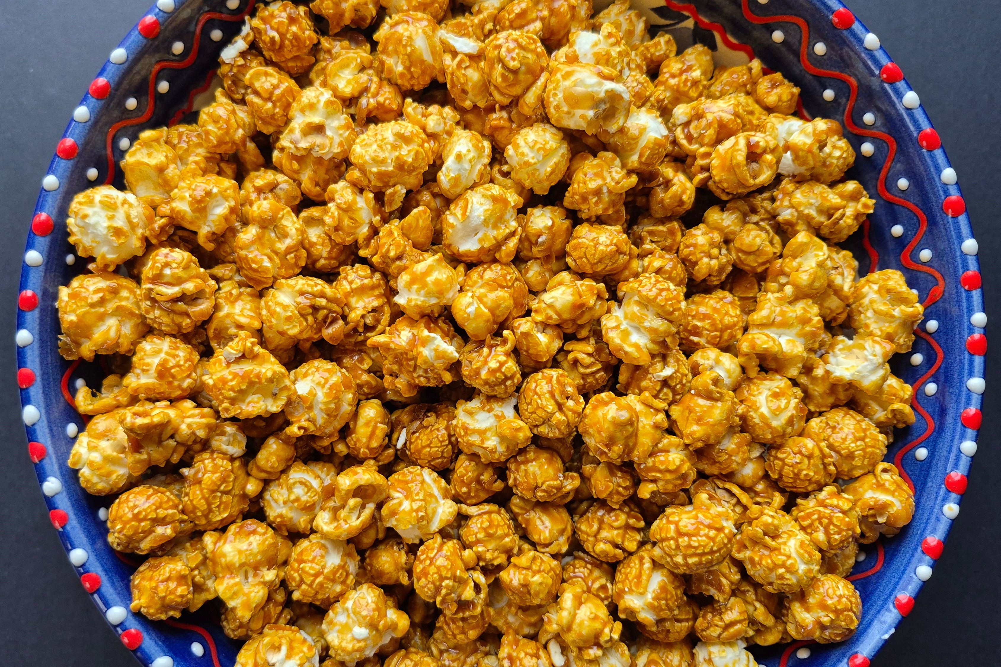 Bowl of caramel popcorn on a dark background